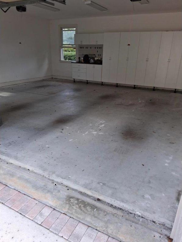 Stained garage floor before