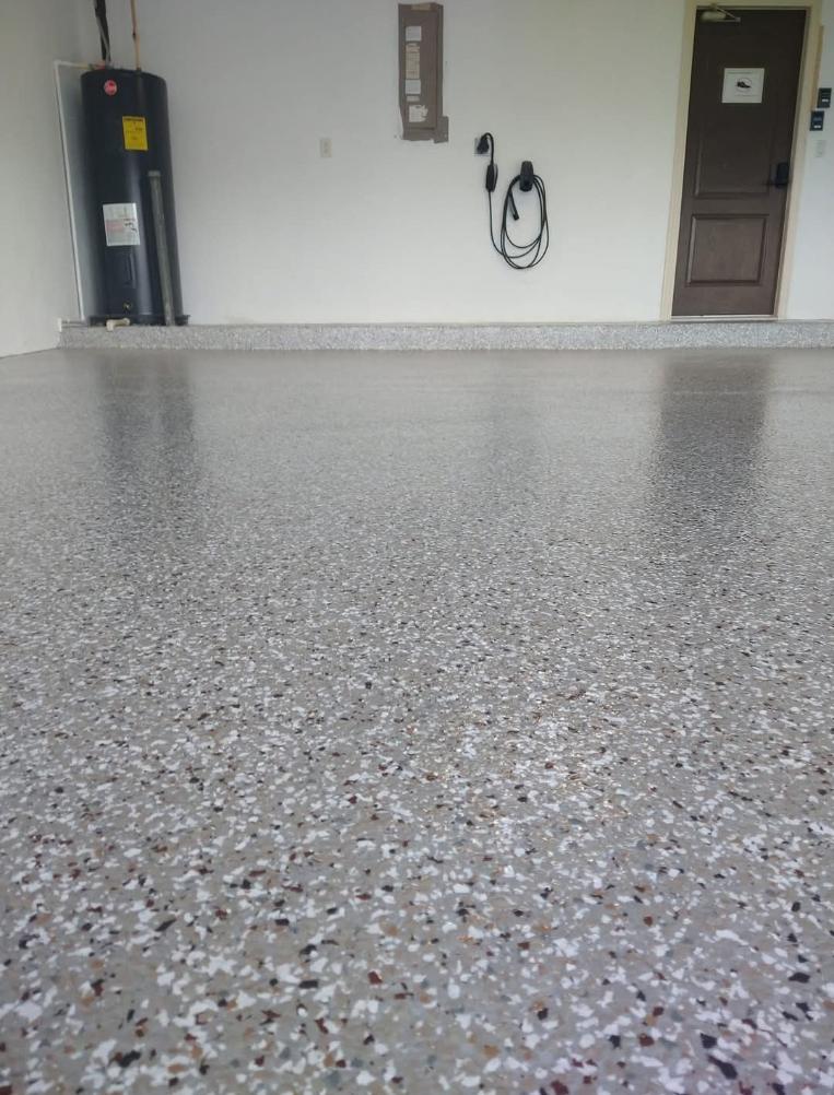 Grey and white flake garage floor with a gloss sealer