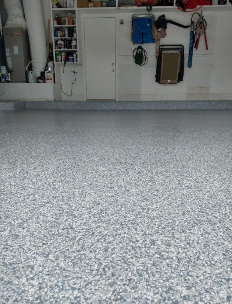 Flake epoxy garage floor finished in grey and white