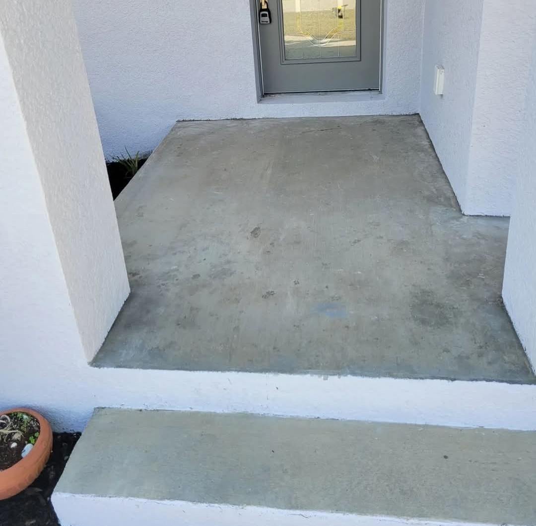 Bare grey concrete front entry before coating
